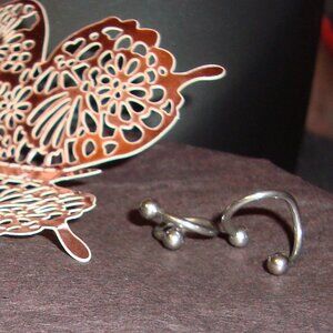 two surgical steel cartilage piercings